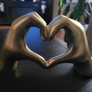 Gold hand heart sculpture